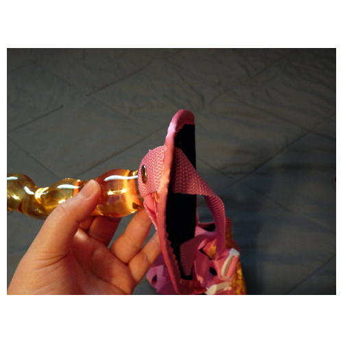 Dildo in O-ring, straps through slits
